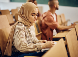 Normal_young-woman-wearing-hijab-while-taking-notes-durin-2022-12-06-01-01-38-utc