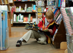 Normal_child_reading_at_brookline_booksmith