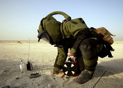 Normal_us_navy_050510-n-4309a-114_hull_maintenance_technician_2nd_class_carl_harris_inspects_the_remaining_high_explosive_material_from_a_disrupted_improvised_explosive_device_during_a_training_exercise_in_bahrain