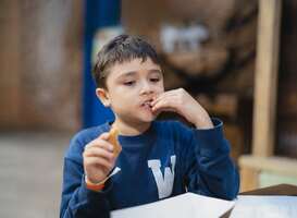 Normal_hungry-boy-eating-churros-stick-schoolkid-having-s-2021-11-30-19-48-41-utc-min