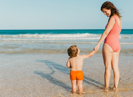 Normal_happy-mother-and-baby-standing-near-waving-sea-2022-09-29-22-22-08-utc