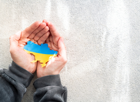 Normal_hands-holding-national-flag-of-ukraine-in-the-shap-2022-12-11-23-59-24-utc