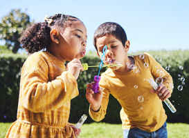 Normal_playing-garden-and-children-blowing-bubbles-for-e-2023-05-03-05-37-19-utc