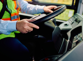 Normal_close-up-of-school-bus-driver-driving-a-bus-2023-04-28-01-21-50-utc