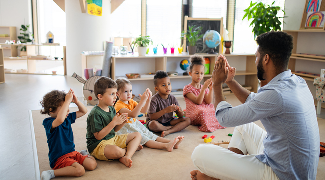 Carousel_nursery-school-children-with-man-teacher-sitting-o-2022-01-19-00-03-58-utc