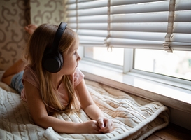 Normal_sad-kid-listening-music-via-wireless-headphones-at-2022-11-12-02-51-45-utc