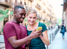 Normal_young-interracial-couple-using-a-mobile-phone-2022-10-11-19-29-34-utc