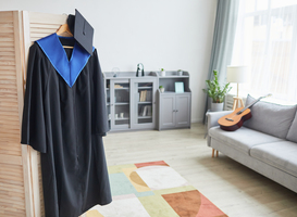 Normal_graduation-gown-on-hanger-at-home-2021-09-24-04-18-14-utc