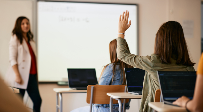 Carousel_rear-view-of-student-raising-hand-to-ask-a-questio-2023-11-27-05-13-12-utc