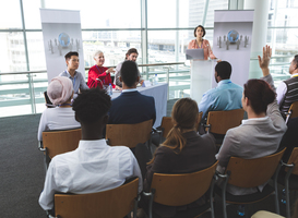 Normal_businesswoman-raising-hand-in-business-seminar-in-2023-11-27-05-25-59-utc