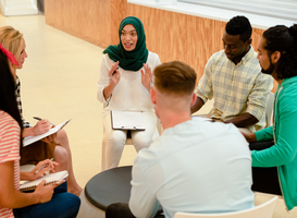 Normal_diverse-business-people-sitting-together-and-havin-2023-11-27-05-22-59-utc