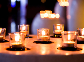 Normal_flame-of-many-candles-burning-on-blurred-lights-ba-2023-11-27-05-08-40-utc