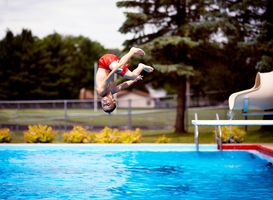Normal_boy-doing-a-flip-off-of-a-diving-board-into-a-pool-2023-11-27-05-29-09-utc