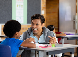 Normal_diverse-male-teacher-using-tablet-teaching-childre-2023-11-27-05-19-24-utc