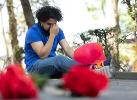 Normal_a-man-sitting-on-a-bench-holding-flowers-with-red-2023-11-27-04-51-49-utc