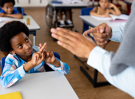 Normal_diverse-male-teacher-teaching-school-boy-using-sig-2023-11-27-05-36-03-utc