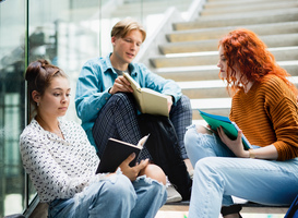 Normal_university-students-sitting-on-stairs-and-talking-2022-01-18-23-34-37-utc