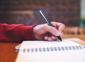 Normal_closeup-image-of-a-woman-writing-on-a-notebook-on-2023-11-27-05-08-23-utc