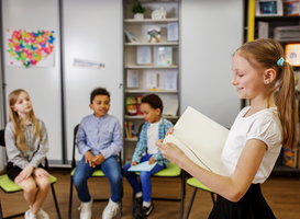 Normal_schoolgirl-standing-in-middle-of-classroom-and-ans-2023-11-27-05-20-02-utc