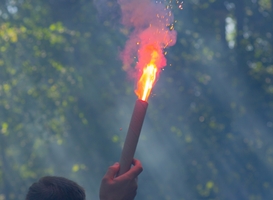 Normal_a-football-fan-is-holding-a-burning-firecracker-2023-11-27-05-12-17-utc