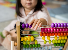 Normal_little-girl-playing-abacus-for-counting-practice-2023-11-27-05-34-47-utc