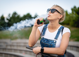 Normal_modern-woman-outdoor-smoking-e-cigarette-at-city-s-2023-11-27-04-50-14-utc