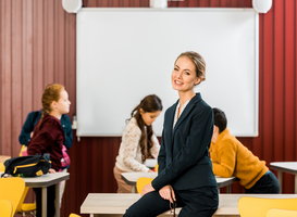 Normal_beautiful-young-teacher-smiling-at-camera-while-ki-2023-11-27-05-20-55-utc