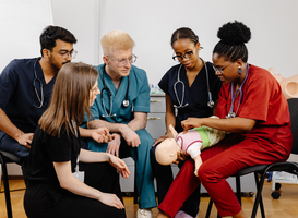 Normal_medical-students-practicing-cpr-on-a-baby-mannequi-2024-06-13-16-57-01-utc