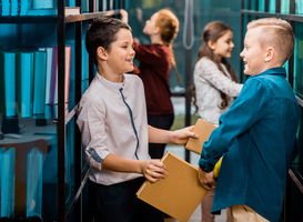 Normal_side-view-of-adorable-happy-schoolkids-holding-boo-2023-11-27-04-55-14-utc