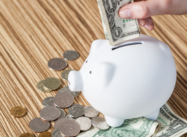 Normal_white-piggy-bank-and-us-dollars-2023-11-27-05-20-31-utc