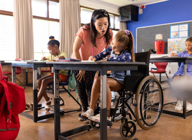 Normal_asian-teacher-assists-a-caucasian-girl-in-a-wheelc-2024-03-15-17-55-04-utc