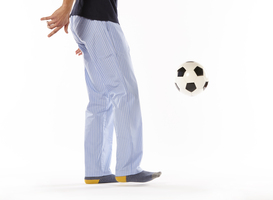 Normal_young-man-in-pajama-playing-football-legs-night-2023-12-06-03-31-23-utc
