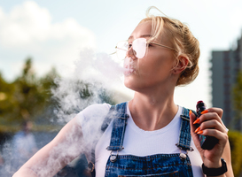 Normal_portrait-of-young-woman-smoking-an-e-cigarette-out-2024-10-31-02-08-51-utc
