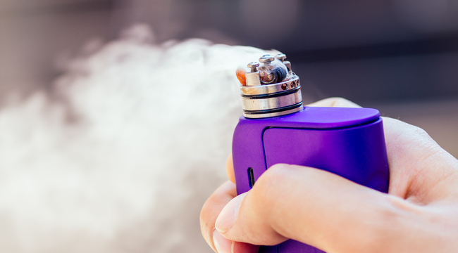 Carousel_purple-vape-in-a-man-s-hand-on-a-modern-background-2024-10-31-04-18-19-utc