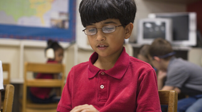 Carousel_boy-reading-book-in-classroom-2025-04-05-11-16-58-utc