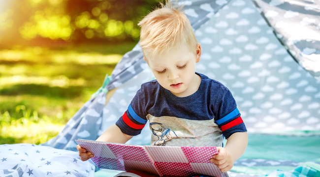 Carousel_a-little-kid-reads-a-book-in-the-park-boy-prescho-2025-03-15-05-30-55-utc
