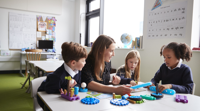 Carousel_female-teacher-and-three-primary-school-kids-worki-2024-10-19-13-48-15-utc