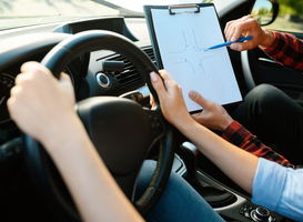 Normal_woman-and-man-with-checklist-driving-school-2024-12-03-16-42-17-utc