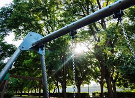 Normal_stands-of-a-metal-swing-in-a-public-park-with-sun-2024-10-21-04-02-34-utc