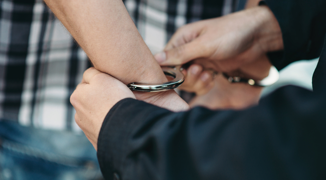 Carousel_police-officer-puts-handcuffs-on-a-car-thief-2024-12-05-04-38-44-utc